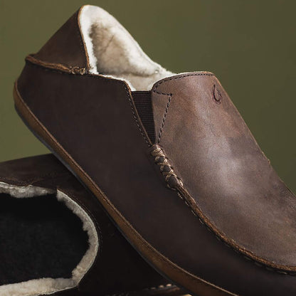 Dark brown suede slipper with cream fleece lining and stitched seams.