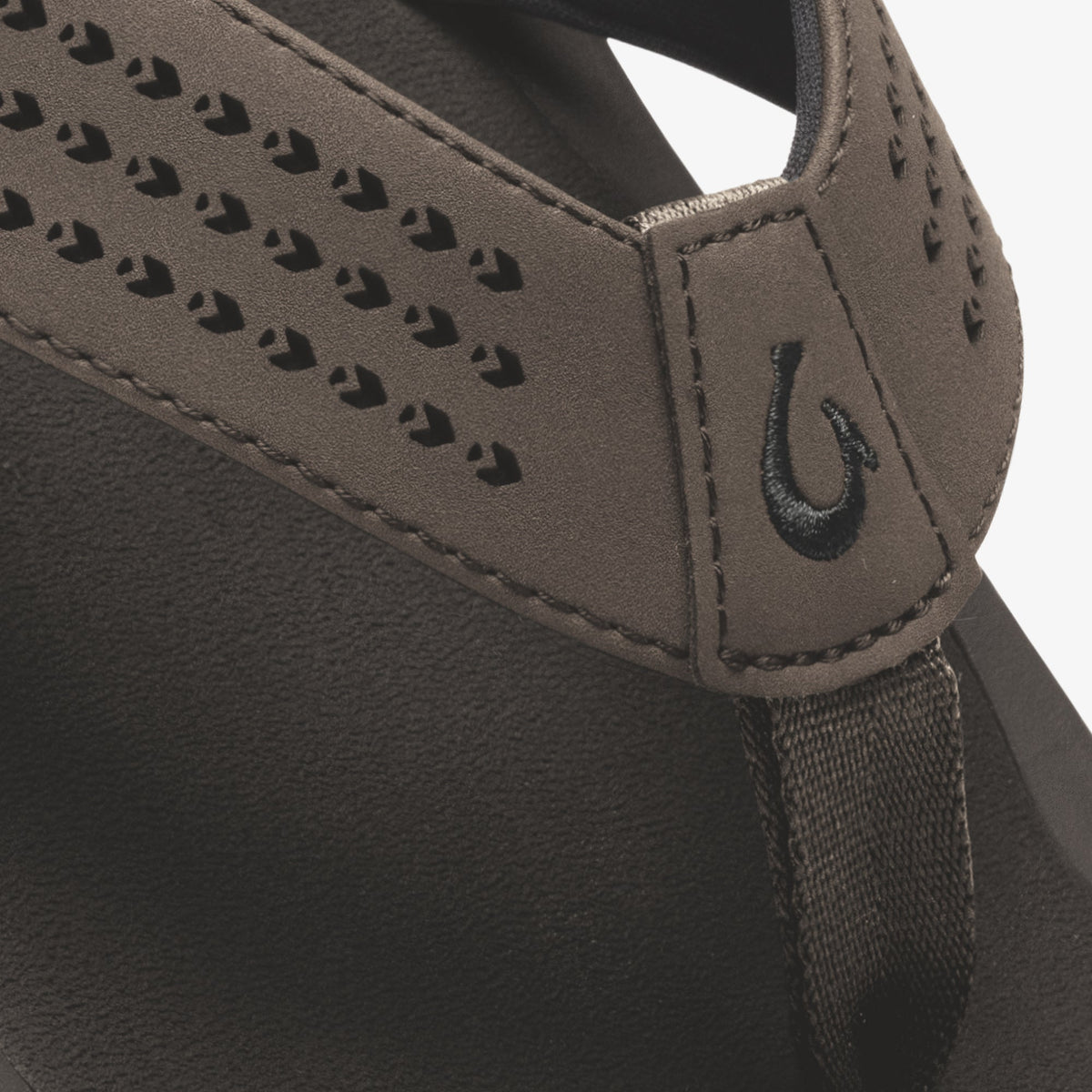 Dark brown slip-on shoe with perforated detailing and elastic side panel.
