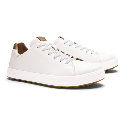 White leather sneakers with tan heel and collar trim, white laces, and tan rubber sole.