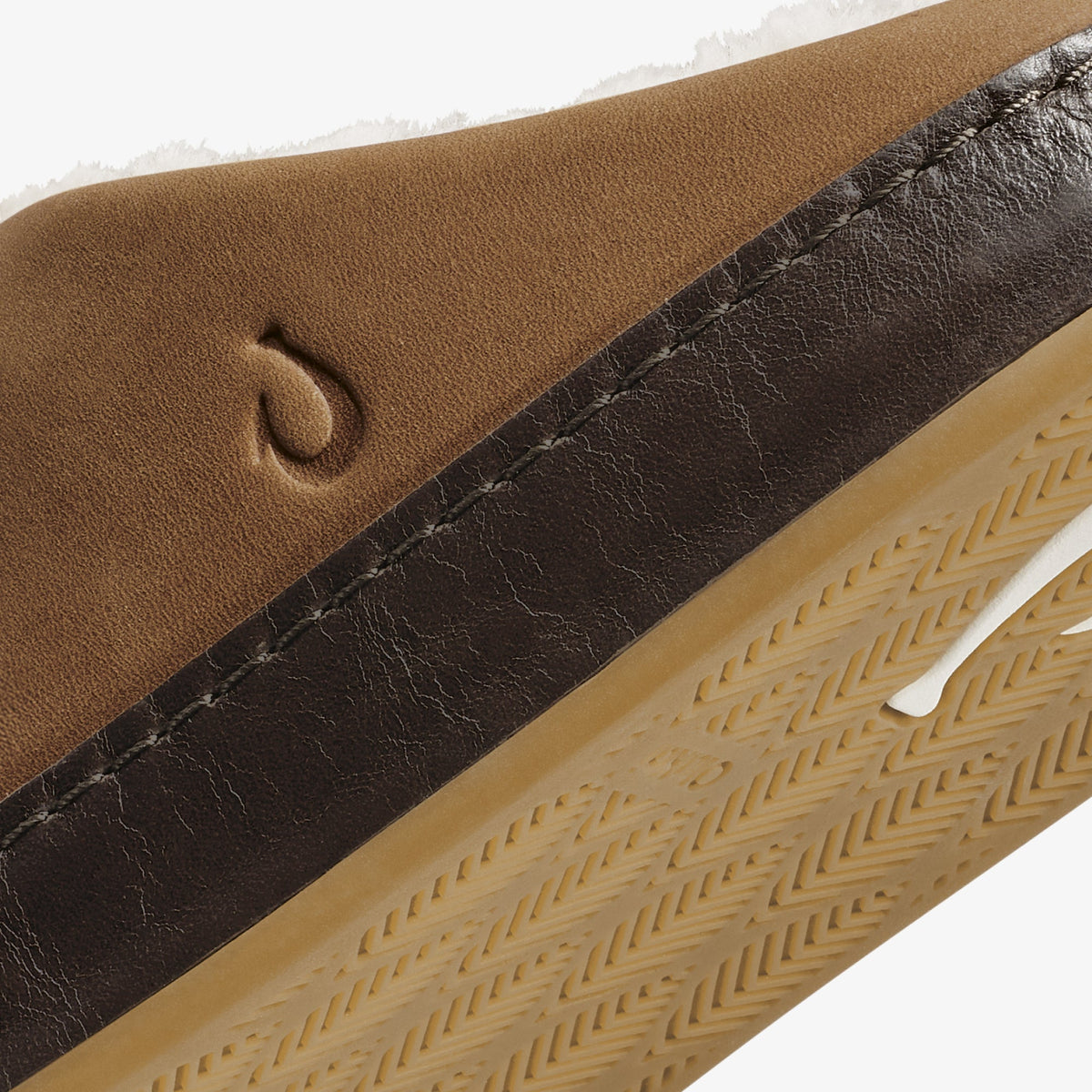 Toffee suede and dark java leather shoe with textured sole and brand logo detail.