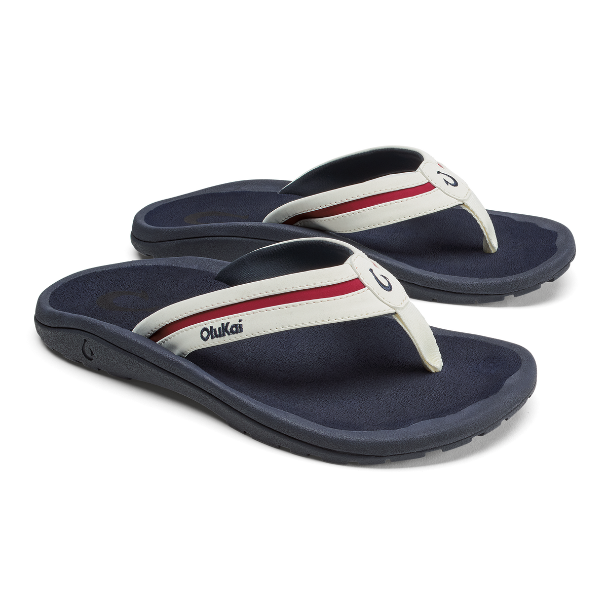 Pair of dark navy thong sandals with white and red striped straps and cushioned footbeds.