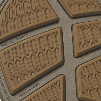 Tan rubber car floor mat with hexagonal tread pattern and "Wet Grip Rubber" text visible.
