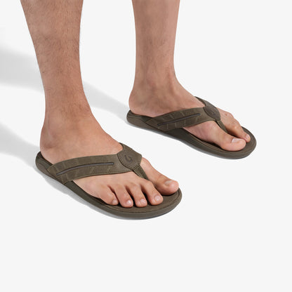 Man wearing mustang-colored thong sandals with textured straps and dark soles.