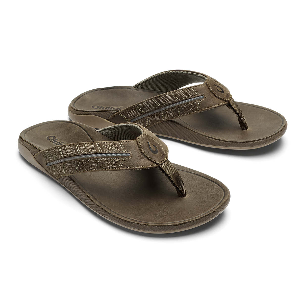 Pair of tan thong sandals with textured straps and cushioned soles.