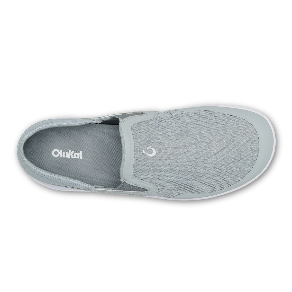 Grey slip-on shoe with textured upper, white sole, and OluKai branding on insole, shown from above.