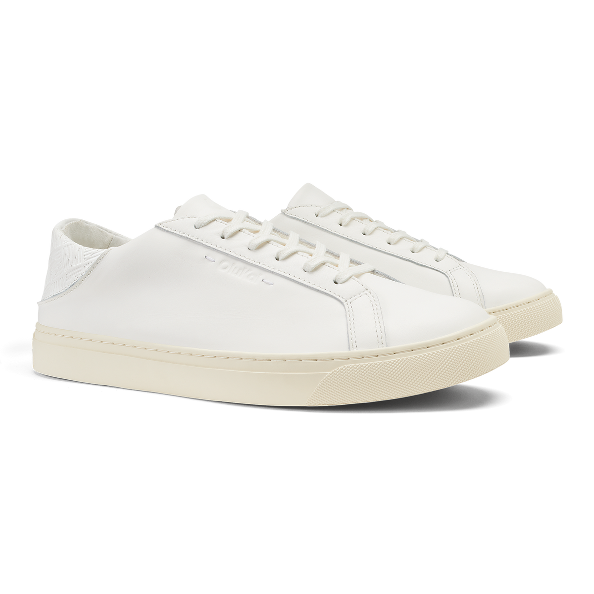White leather lace-up sneaker with cream-colored sole and white stitching detail.