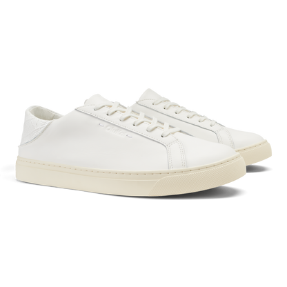 White leather lace-up sneaker with cream-colored sole and white stitching detail.