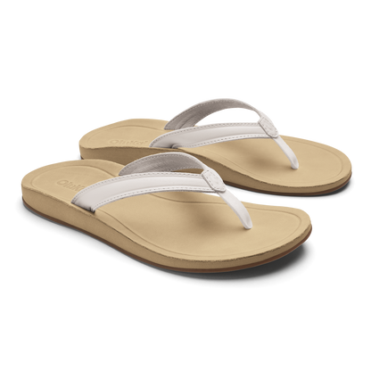 Pair of tan flip-flops with bright white straps and gray trim on cushioned soles.