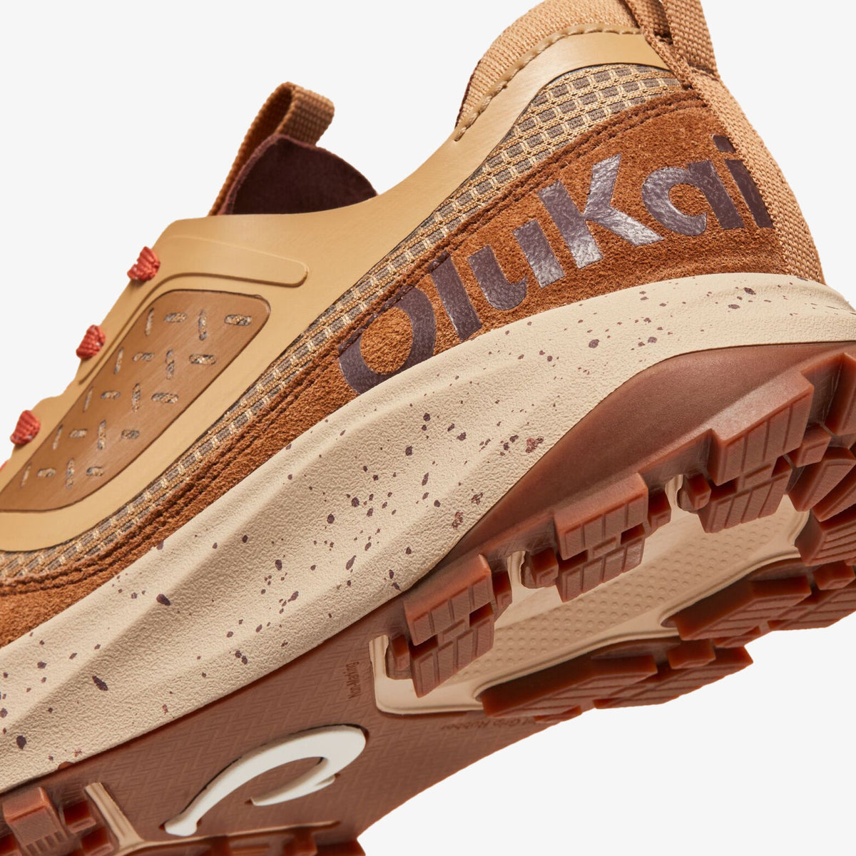 Beige and brown athletic shoe with "Makiki" branding, showing textured midsole and patterned upper side view.