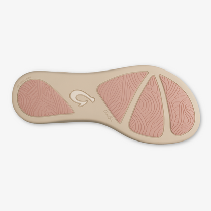 Beige and mauve sole with curved design and textured grip pattern, viewed from underneath.