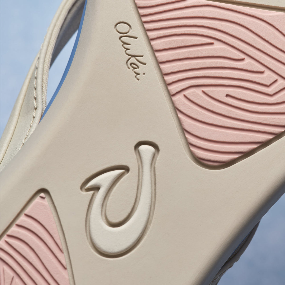 Cream and mauve/pink tapa-patterned sandal with embossed logo detail and textured upper sole.