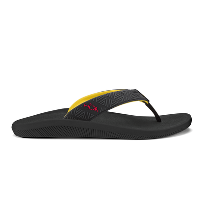 Black flip-flop sandal with yellow and patterned black thong strap and textured sole.