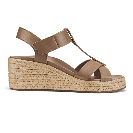 Tan leather wedge sandal with crossed straps, ankle strap, and woven espadrille sole.