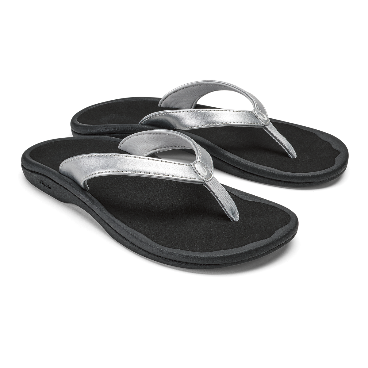 Pair of black flip-flops with silver metallic thong straps and cushioned soles.