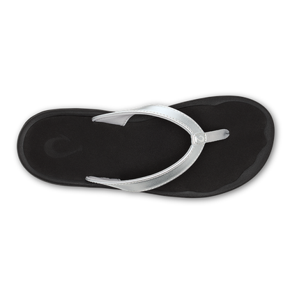 Black flip-flop sandal with silver metallic thong strap and circular toe post detail.